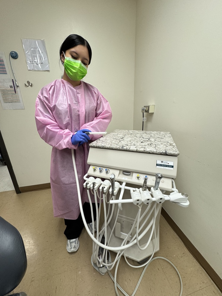A dental Student next to the mobile dental lab