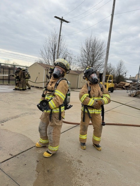 This is two of the public safety students in their fire training gear.