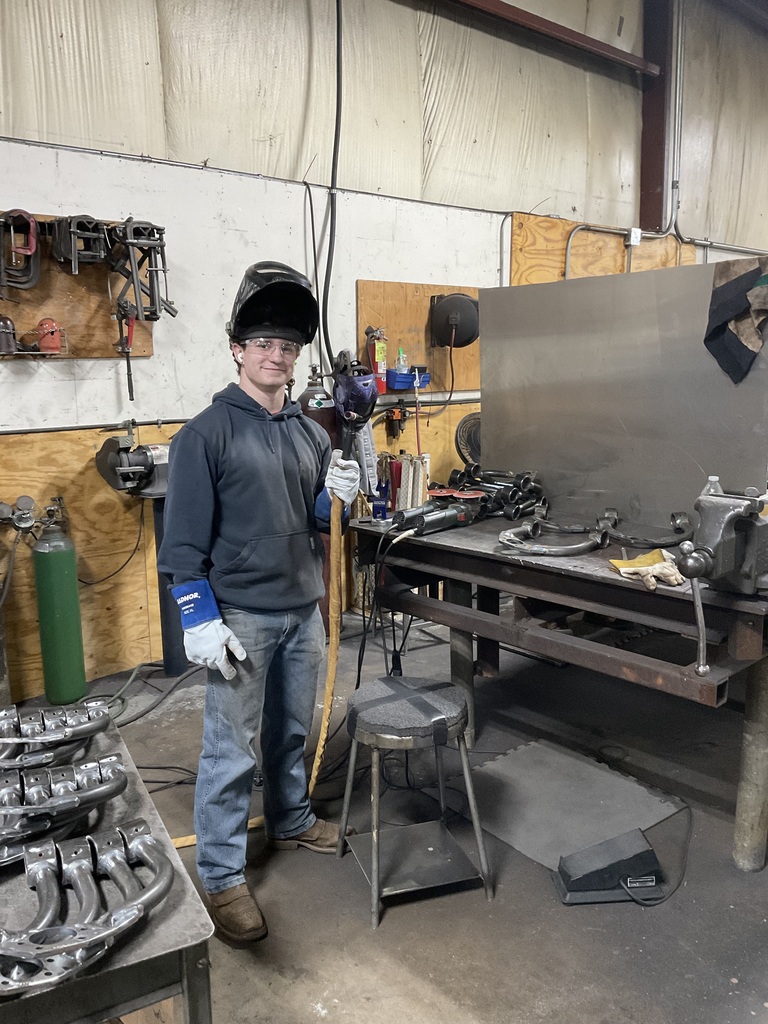 As a picture of Vincent in the library with welding equipment on Leahy helmet smile on his face and safety glasses