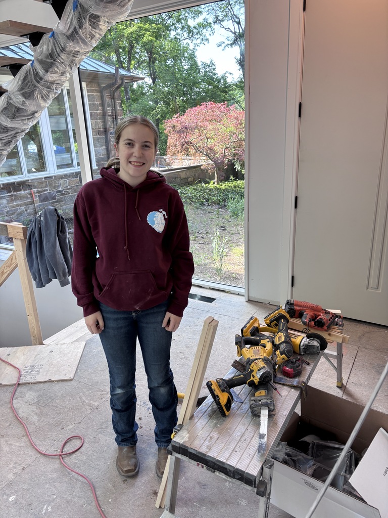 A picture of Rebecca working at JR Maxwell's builder she's at work site