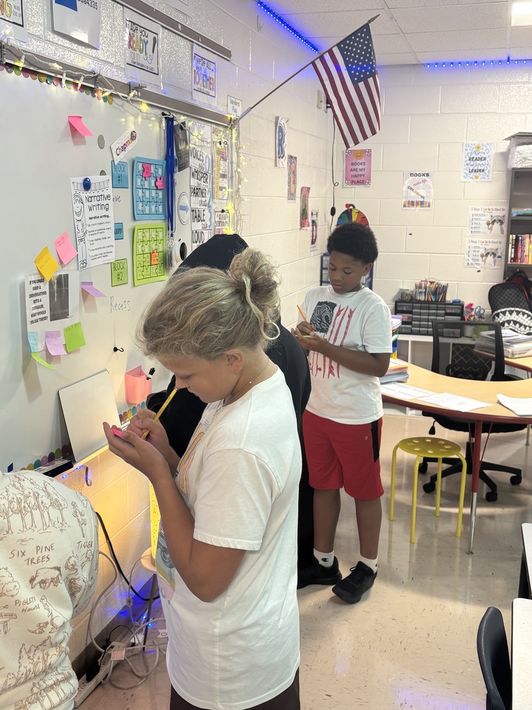 A group of students writing.