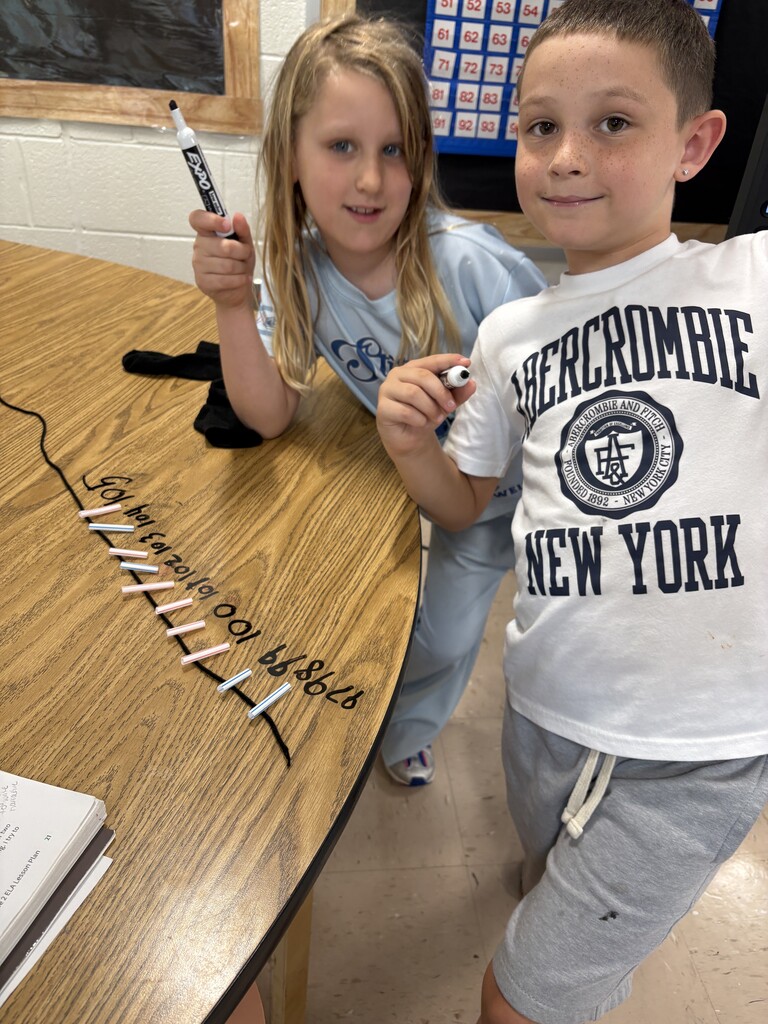 Two students working on a number line.