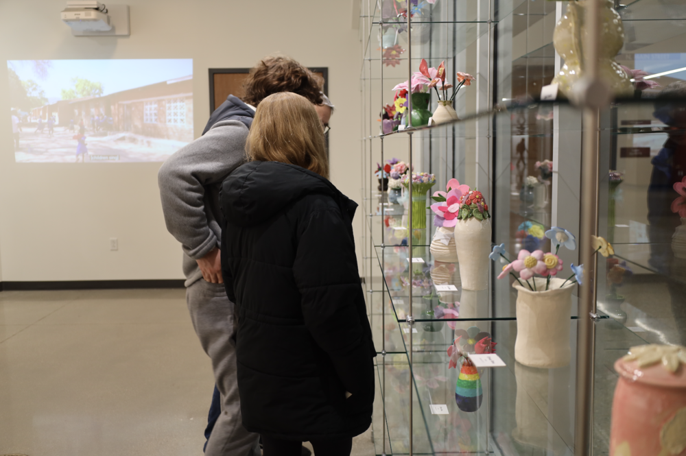 Community members view student artwork in the Project Joy Art Gallery