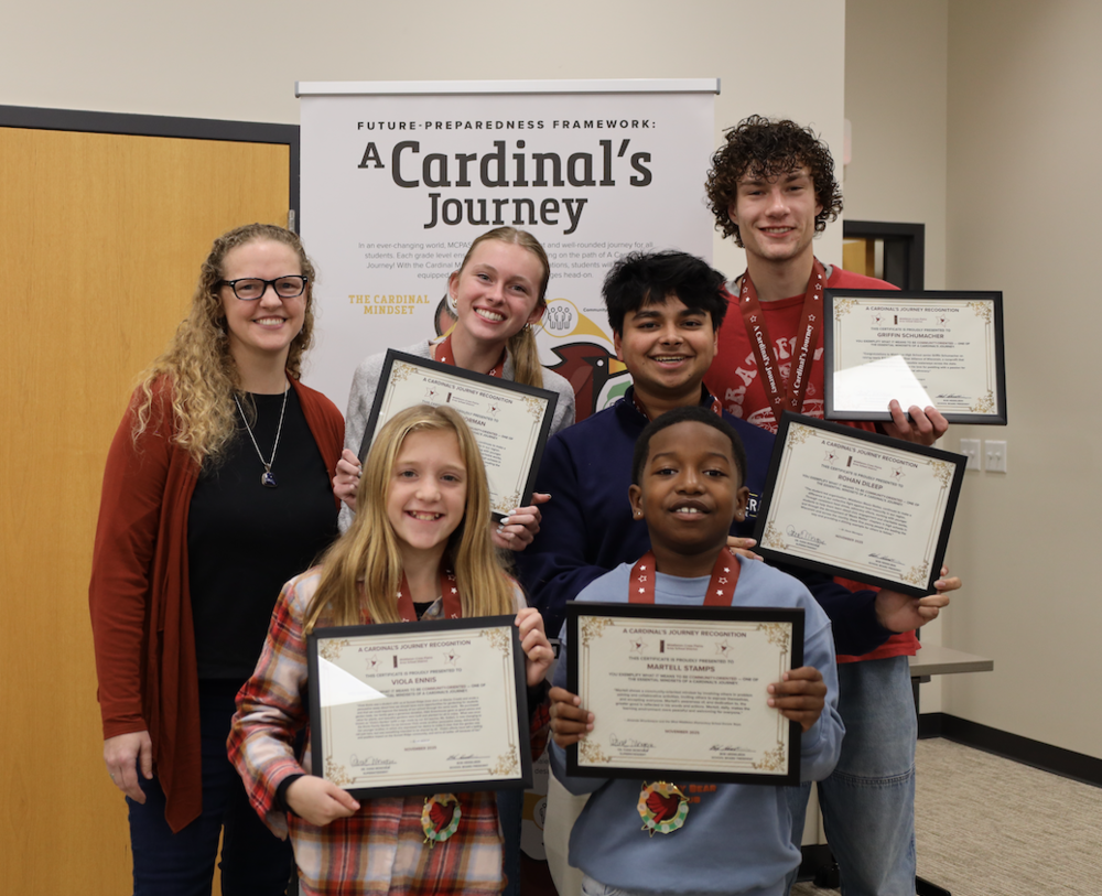 Five students pose with their Cardinals's Journey award  and  Board of Education Vice President Catherine Kells 