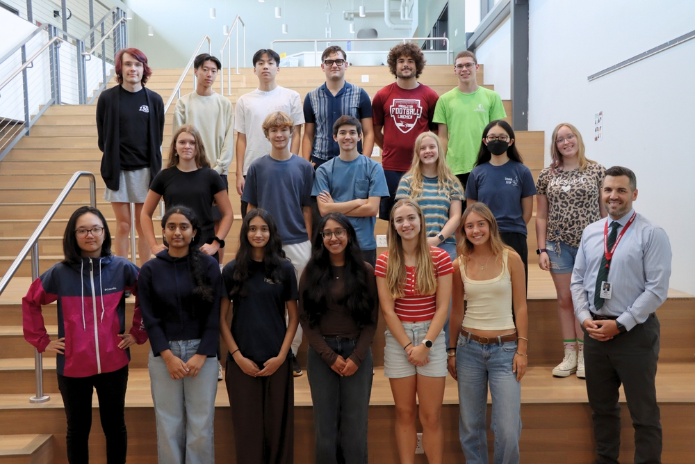 National Merit Semifinalist students smile and pose with Principal Bobbie Reinhart