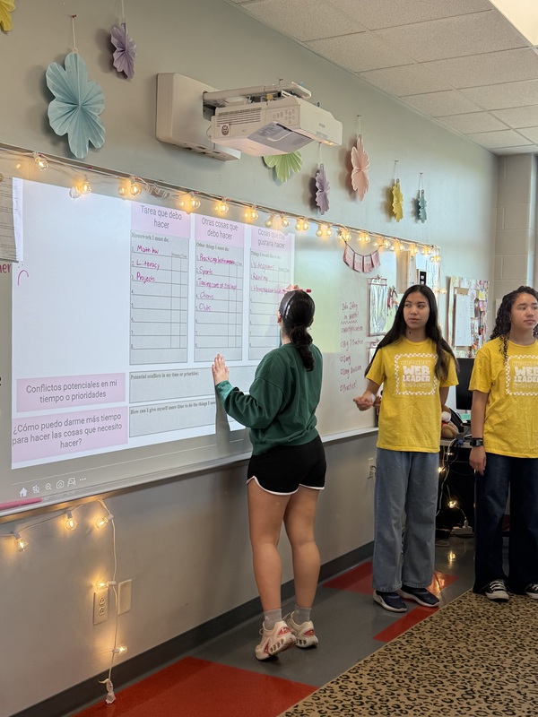 Student mentors talk about time management strategies while one student writes on the whiteboard
