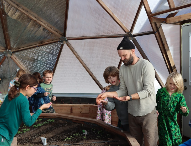 Ren with students in the greenhouse