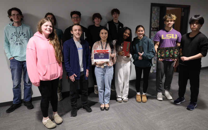 Qin Tian with her students and award