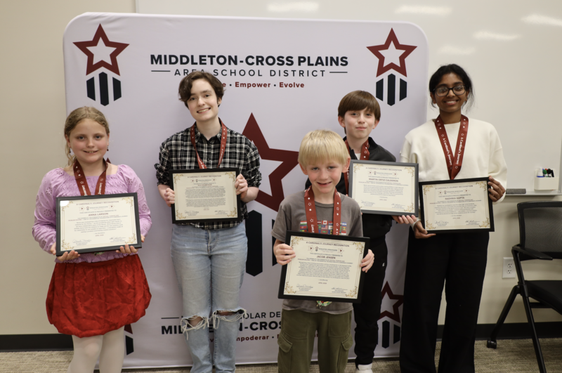 Students smiling and holding their Cardinal's Journey Awards