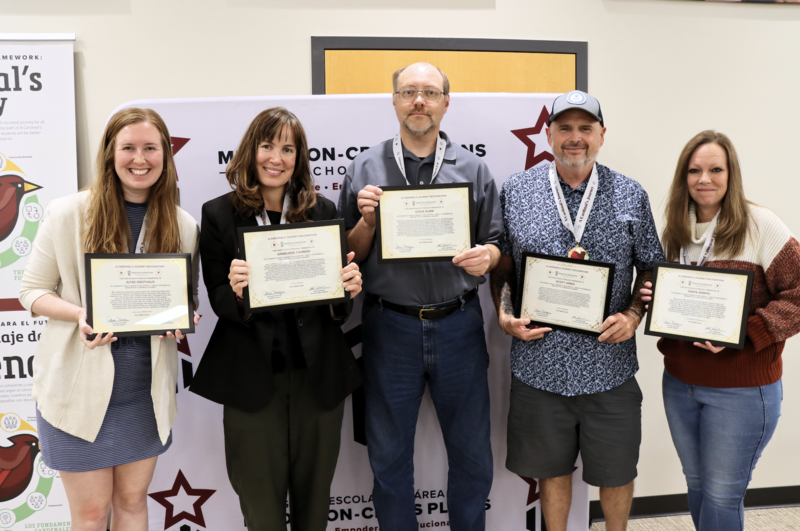 Five staff members smiling and holding their Cardinal's Journey Awards