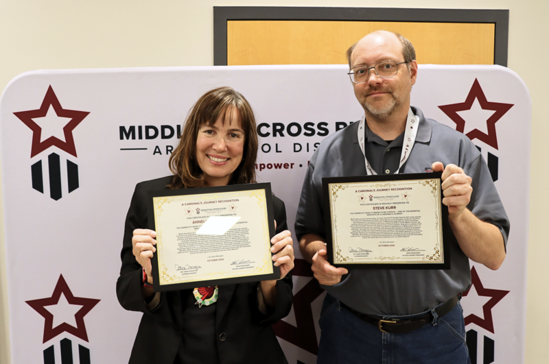 Anneliese Cannon and Steve Kurr smiling and holding their Cardinal's Journey Awards