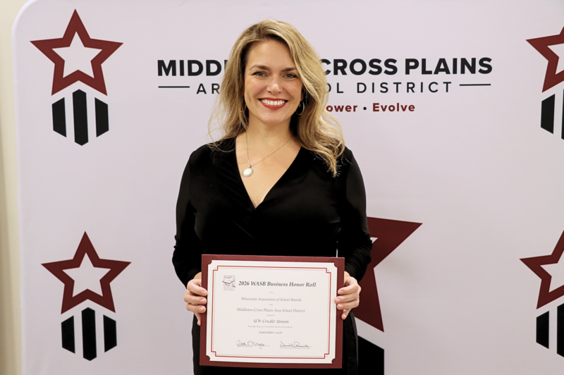 Erin Bykowski smiling and holding WASB certificate