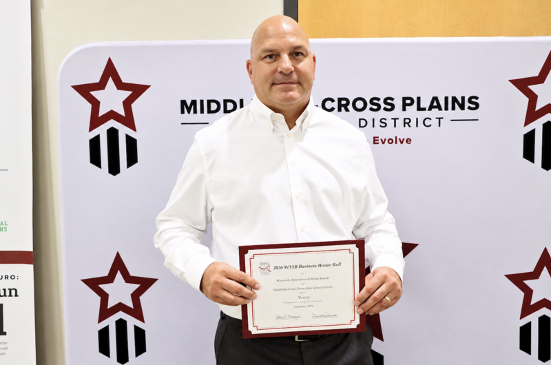 Luke Whitburn smiling and holding WASB certificate