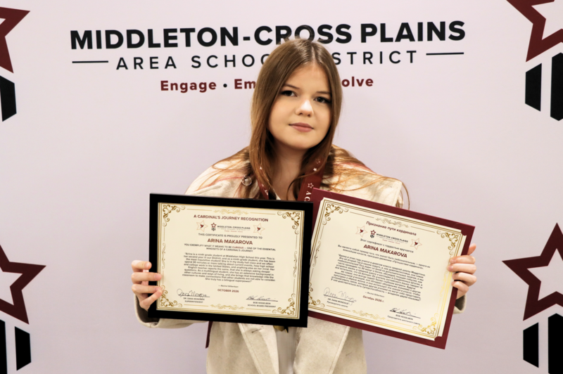 Arina Makarova smiling and holding her Cardinal's Journey Award