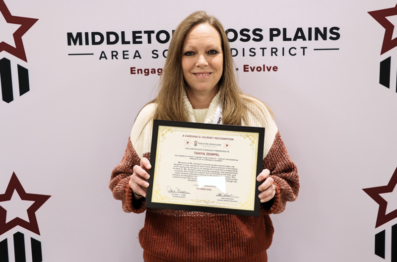 Tanya Zempel smiling and holding her Cardinal's Journey Award