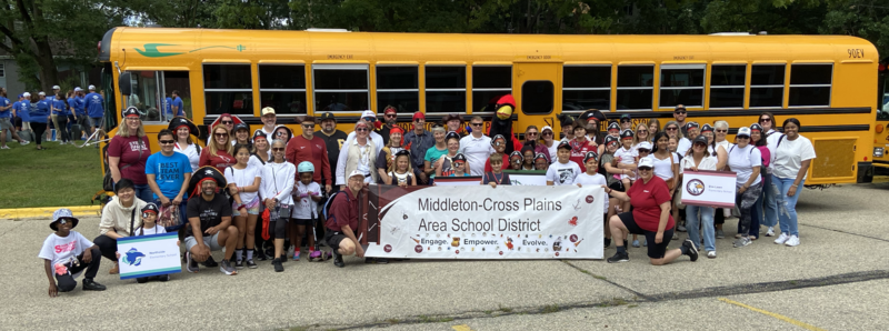 Students and families smiling in a group photo at the good neighbor parade