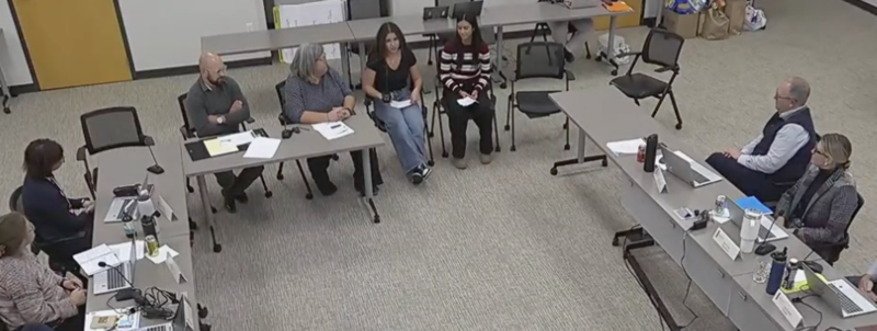 students speaking at a board of education meeting