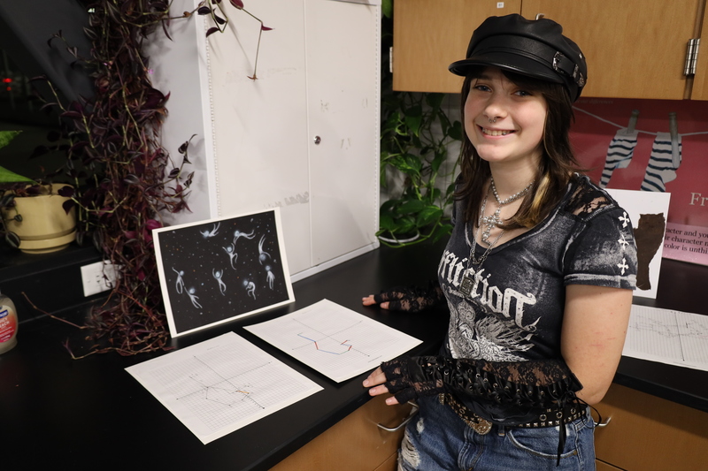 Clark Street Community School student posing with artistic project