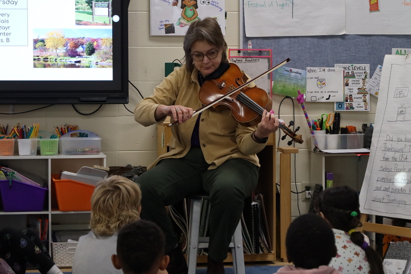 Madison Symphony Orchestra musician playing for Sauk Trail Elementary School students