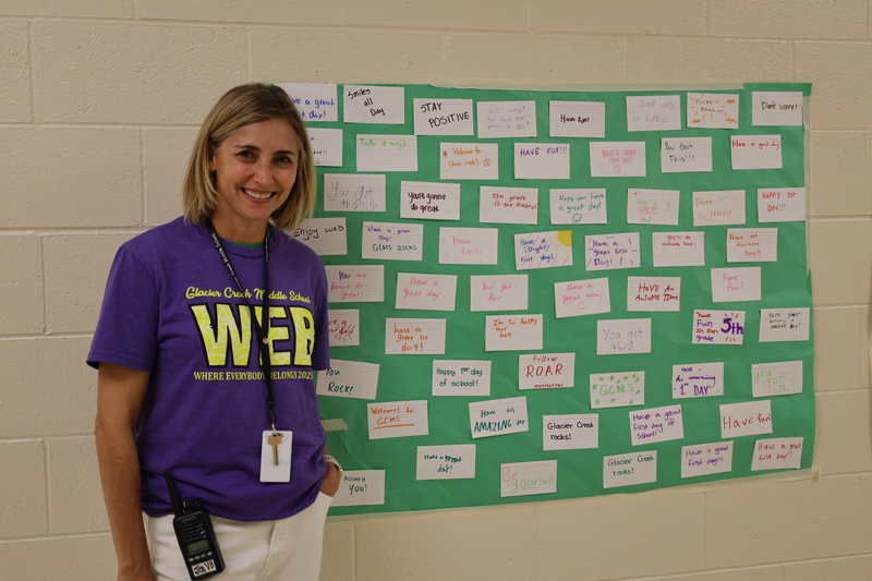 School Counselor Jenny Von Bergen standing next to display of kind words from students