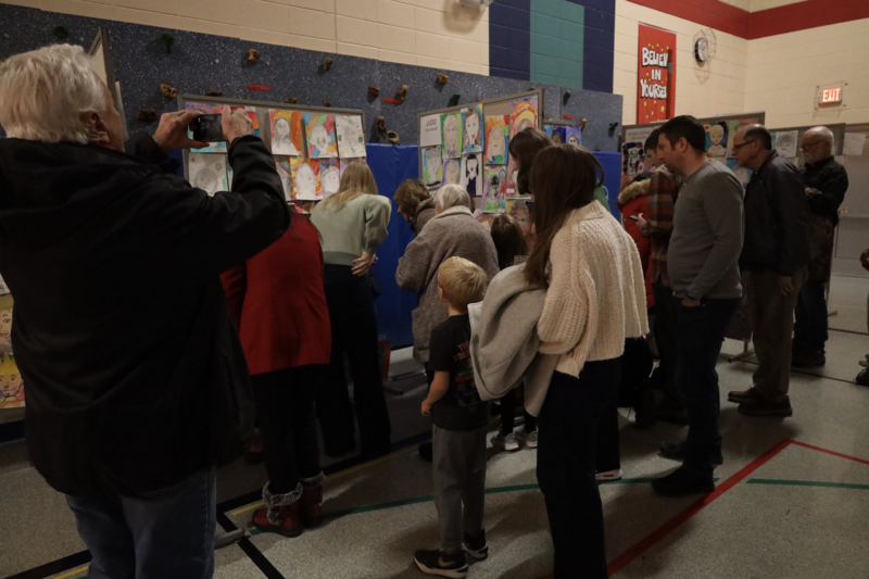 Students and families view artwork at Sunset Ridge Elementary School