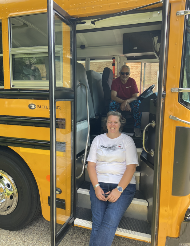 School bus drivers smiling while sitting on the bus