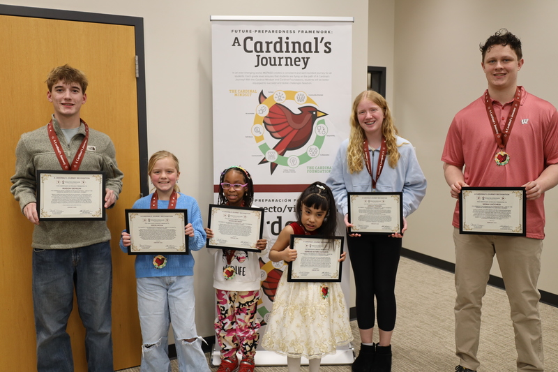 Mason DePauw, Reese Moon, Madeline Saidy, Genesis Sotero Cayaxon, Ainsley Theisen, and Noah Lucchesi smiling and holding their Cardinal's Journey Awards