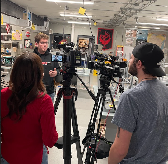 Isaac Zander talks with reporters