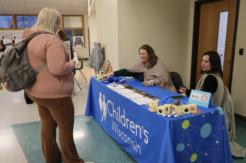 Parent talking to representatives from Children's Wisconsin