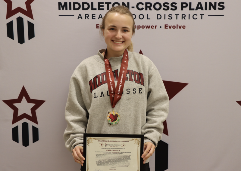 Cate Cassata smiling and holding a certificate