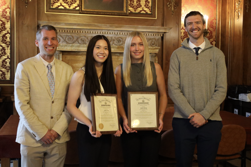 Middleton High School FBLA Advisors Bill Boehm and Brian Zimdars smiling with Sophia Chen and Sophia Pientka in the Wisconsin Capitol Building