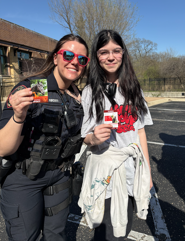 Officer Ruchti and a student with their horse trading cards