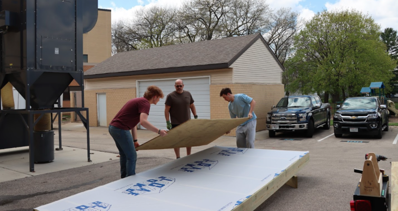 Mr. Zander, Hunter Hull, Everett Kerkman build a solar kiln