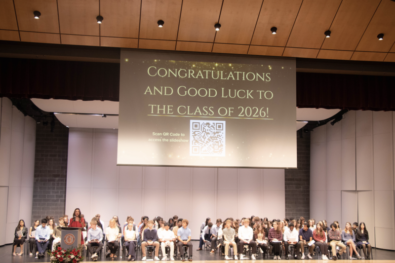 High school students sit on stage during scholarship award ceremony