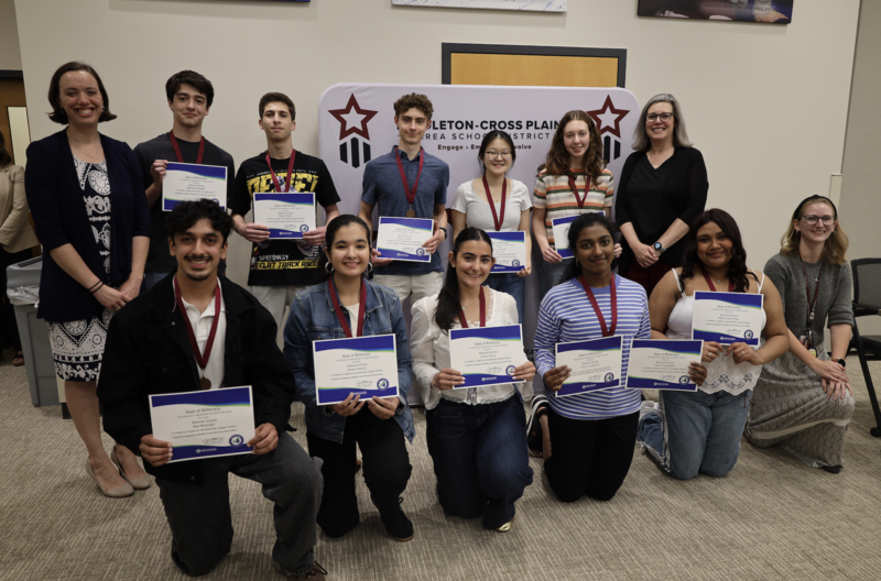 Seal of Biliteracy student recipients and their advisors smile and hold certificates