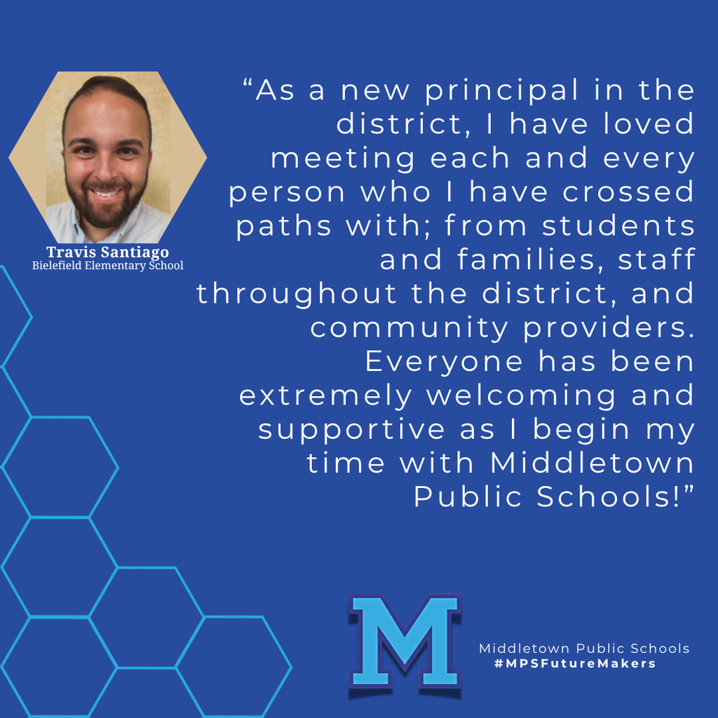 A man with a beard smiling in front of a light brown background. The image includes a quote from the woman and school branding.