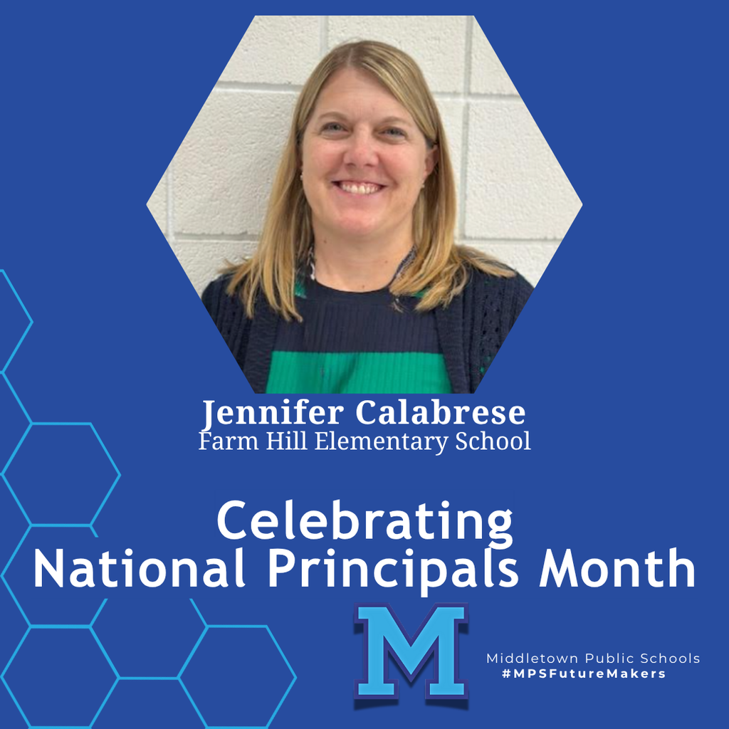 A woman in a blue and green sweater smiling in front of a white brick background. The image celebrates National Principals Month and includes school branding.