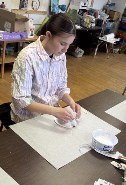 a girl working on her bow