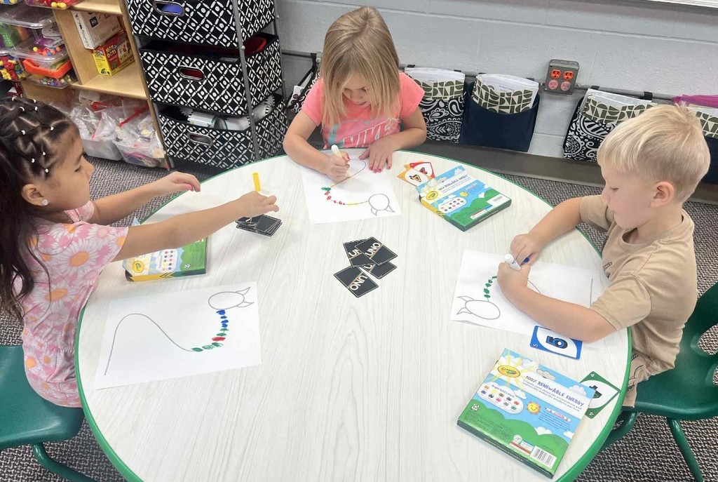 3 kids making Uno monsters