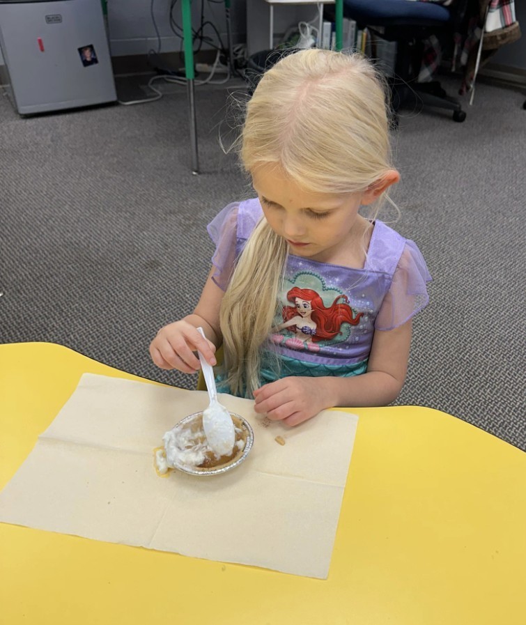 a girl eating pie