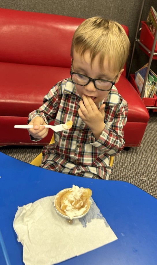 a boy eating apple pie