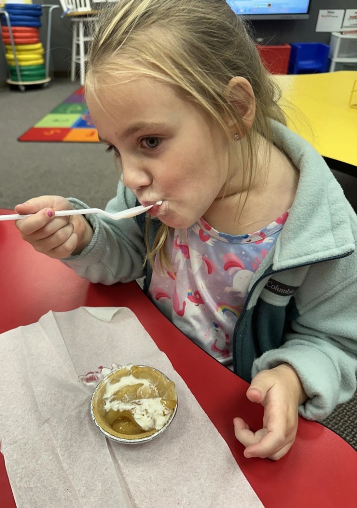 a girl enjoying a pie