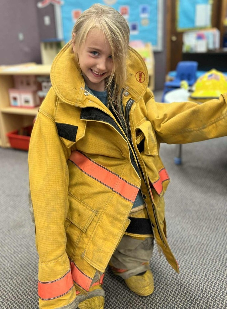 a girl trying on a coat