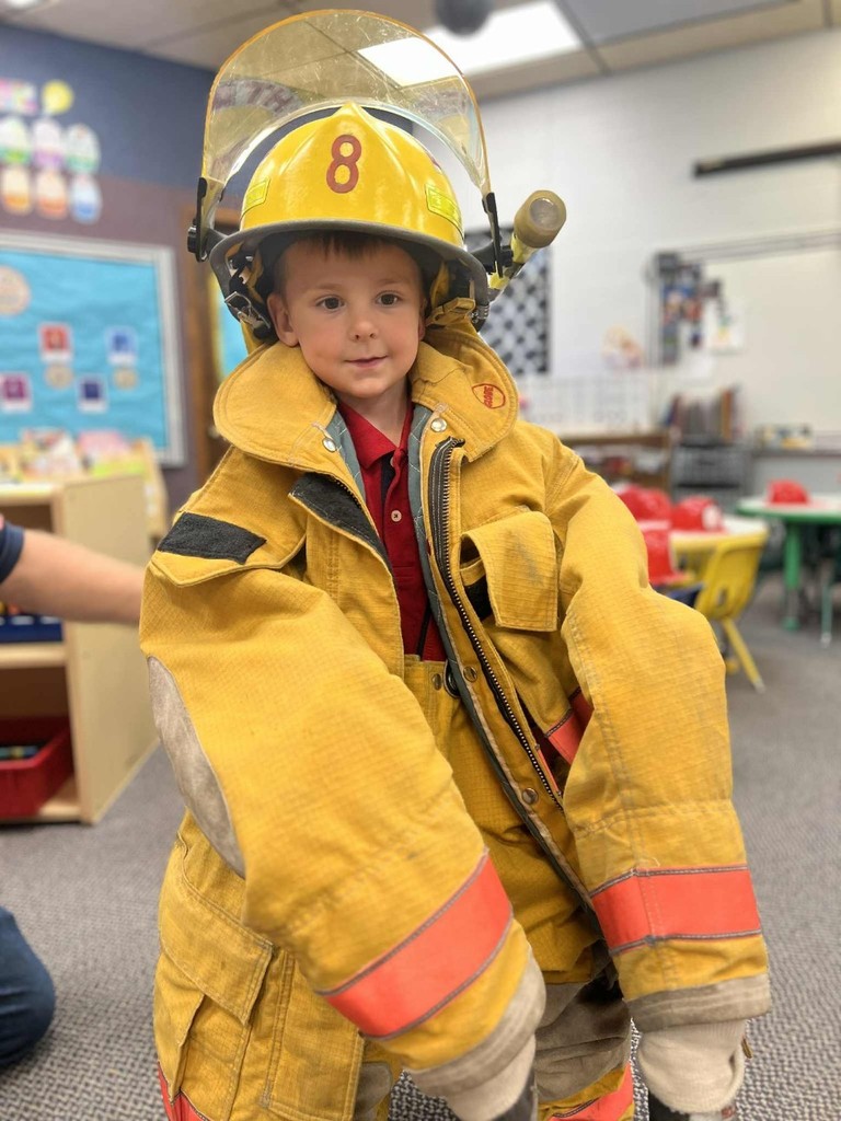 a boy trying on the coat