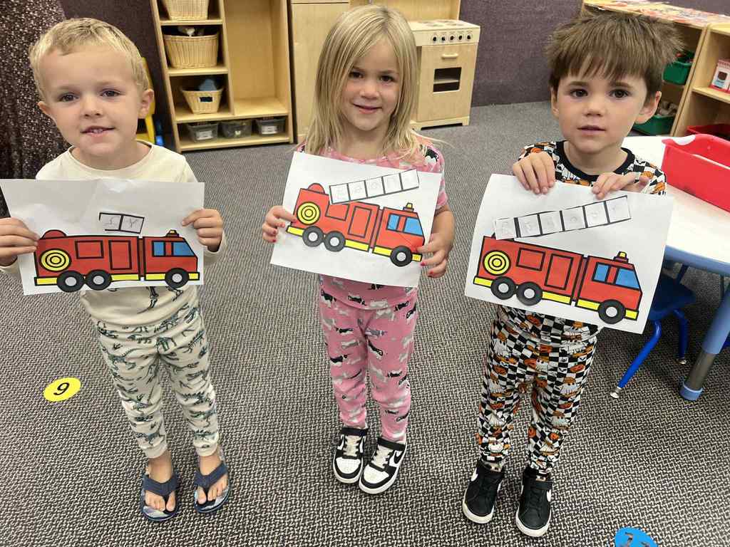 more kids assembling fire trucks