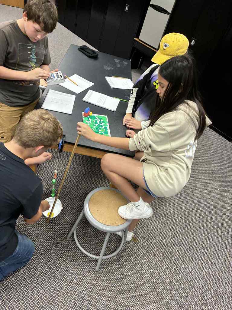 students working with simple machines.