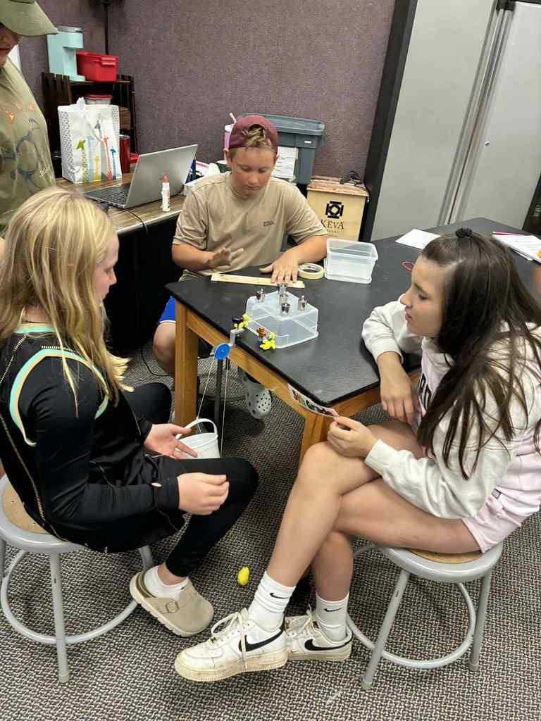 students working with simple machines