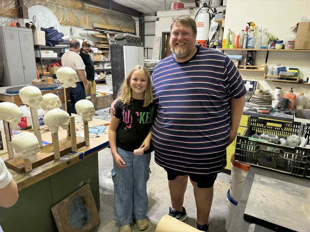 a student and teacher looking at skulls