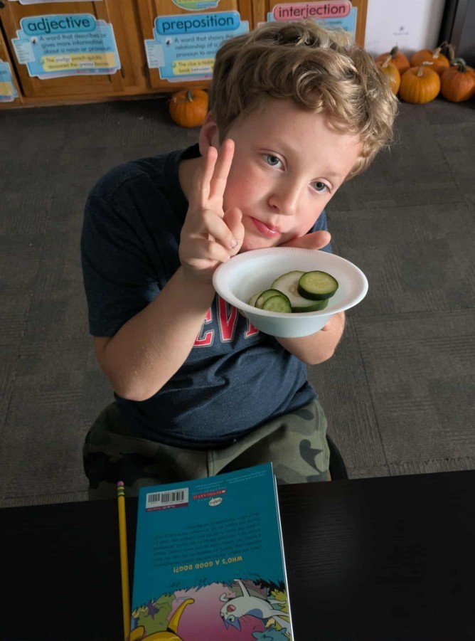 a boy enjoying cucumbers