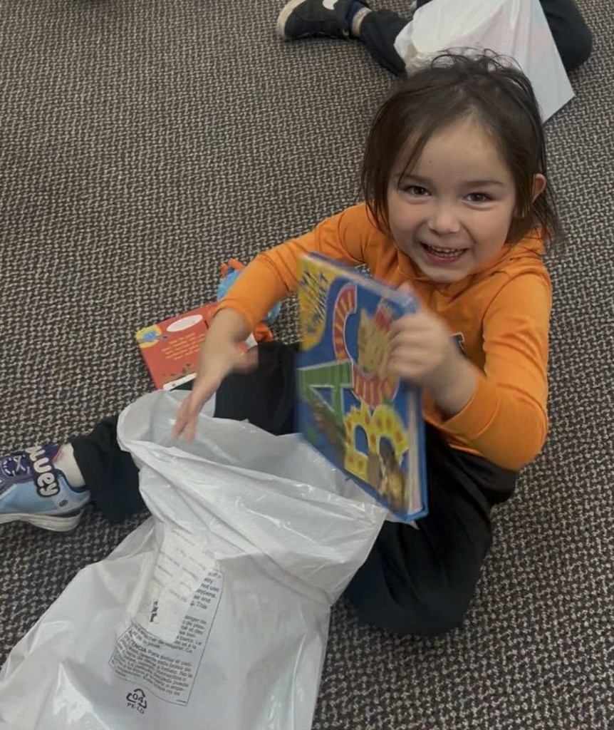 a boy opening his books.